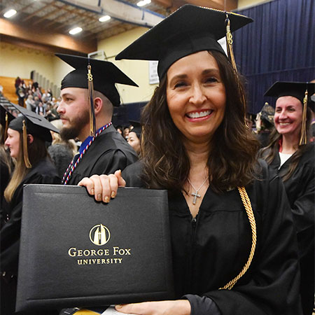 student holding a diploma