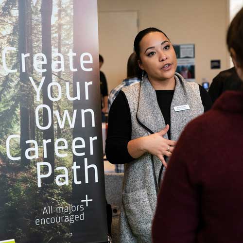 Employer talks to student at a career fair