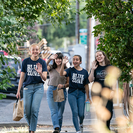 Happy students exploring Newberg neighborhood