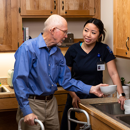 An elderly person getting help from an occupational therapist