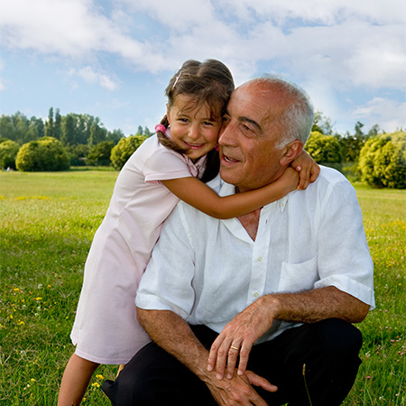 Grandpa with his granddaughter on the beach