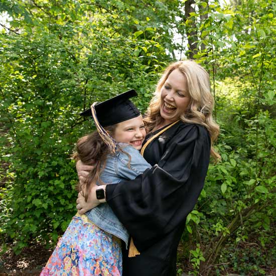 Mother and young daughter in grad regalia