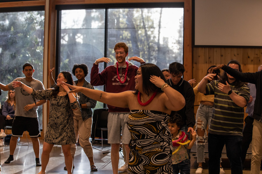 students and employees dancing during a lua event