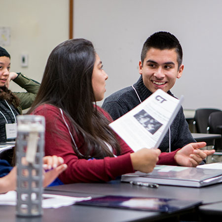 Two students conversing in class