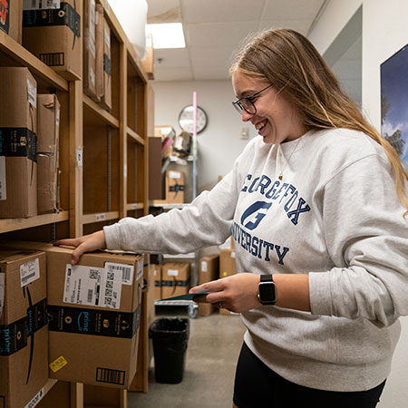 A student getting a package in the mailroom