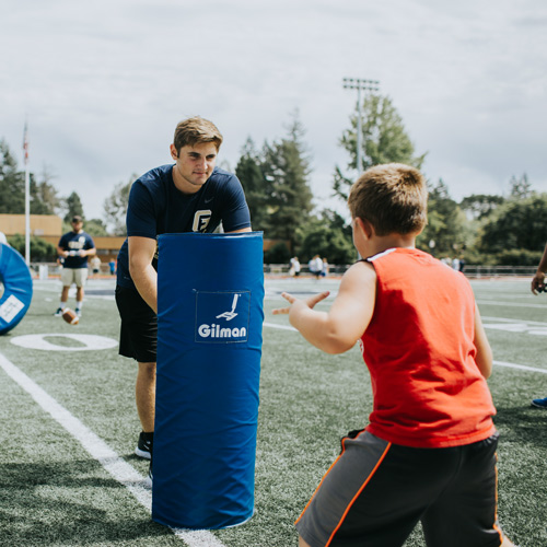 student athlete engages with kid