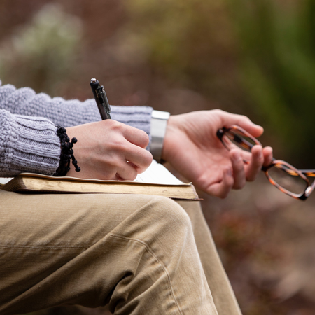 student journaling alongside his Bible