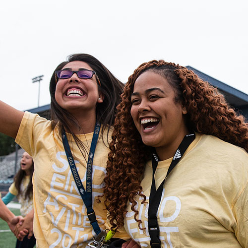 2 students laugh at the camera