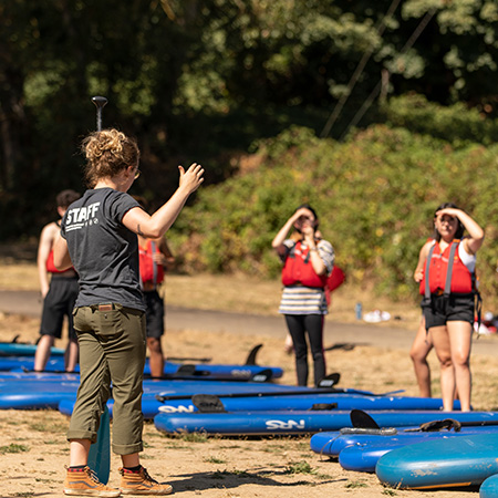 A University Recreation intern giving instructions to students