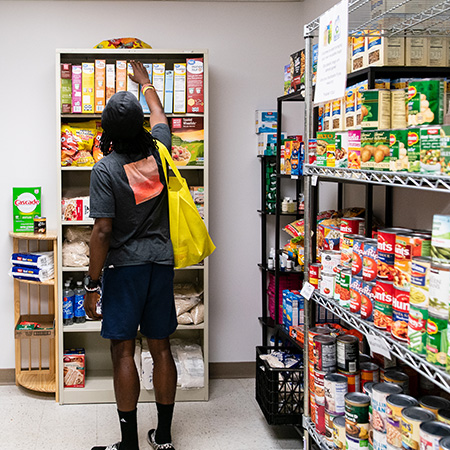 A student shopping at the Bruin community pantry