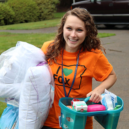 Happy student moving into her dorm