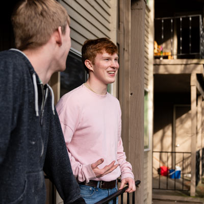 students talk in their apartment