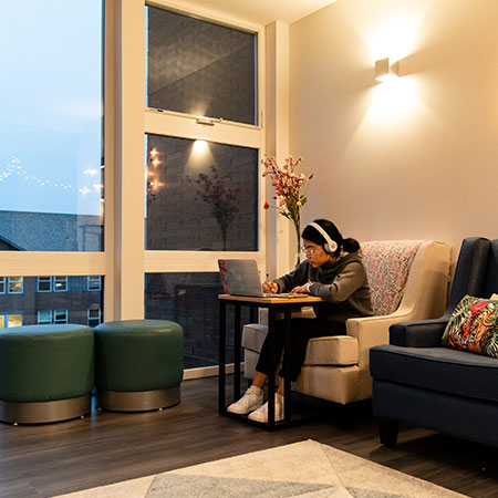 Student studying in a lounge in her residence hall
