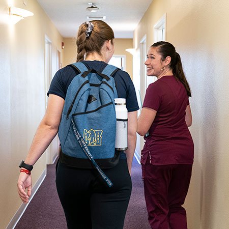 A nurse checking a student in.