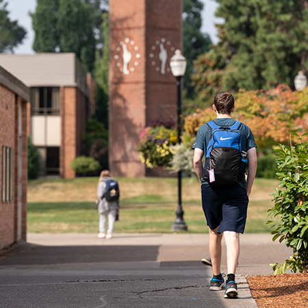 A student walking toward the campus quad