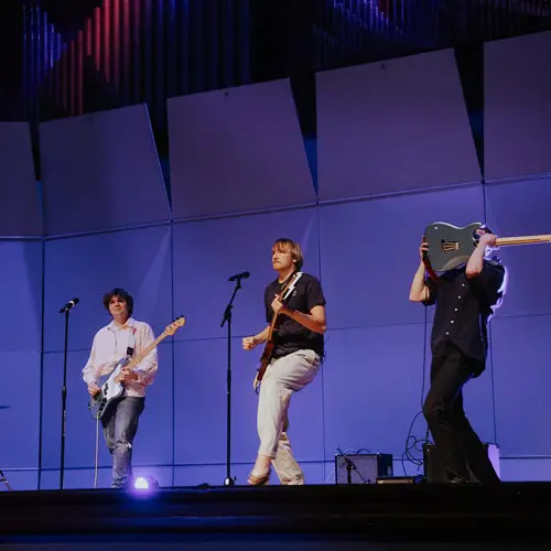 Students sing in a band on stage in Bauman Auditorium