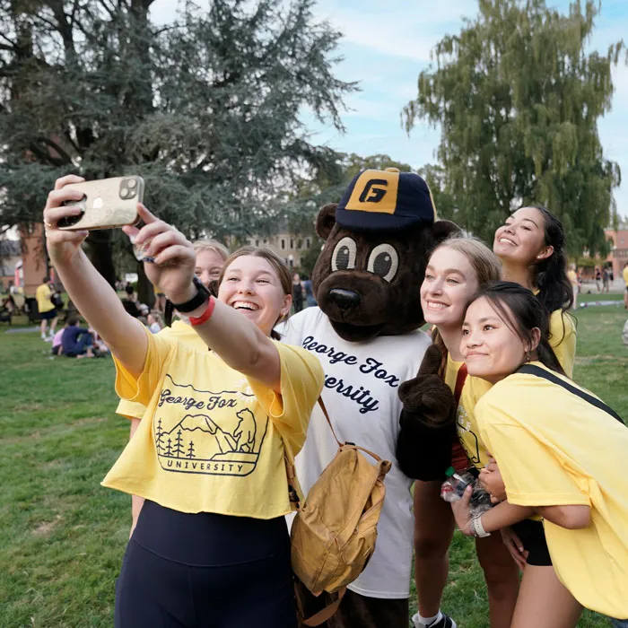 students smile and take a selfie with mascot Pennington, during welcome weekend