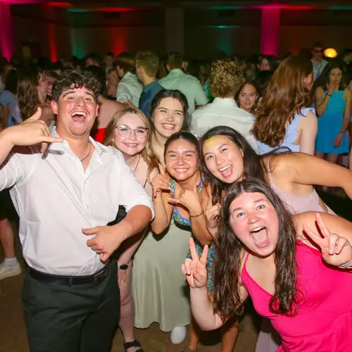 Students pose for a silly photo in formal wear