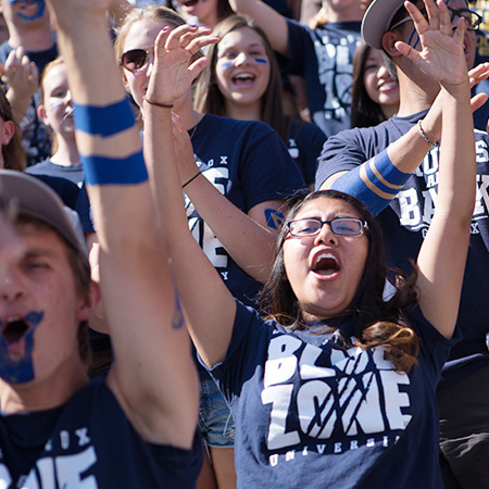 Student fans cheering at the football game