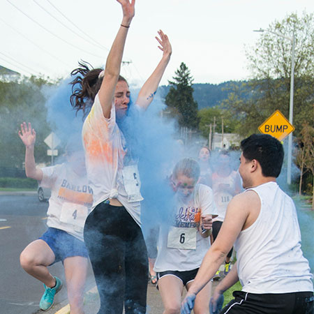 Students getting covered with colored powders 