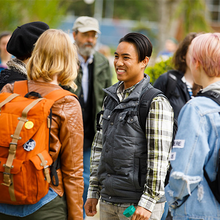 A group of students talking and smiling