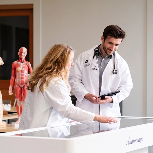 Instructor showing some anatomical images to students in the Physician Assistant classroom
