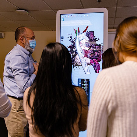 Instructor showing some anatomical images to students in the Physician Assistant classroom