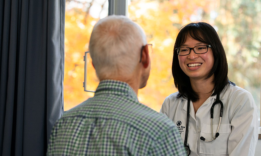 A PA student in practice with an elderly patient