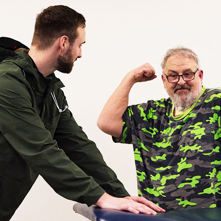 Physical Therapist helping man with chronic pain