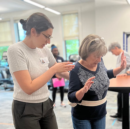 Therapist helping woman do exercises