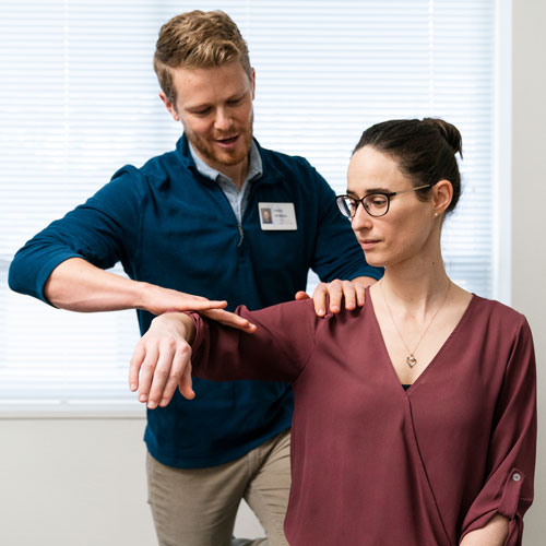 Therapist realigns someone's elbow