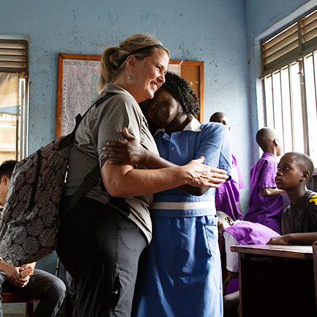 A Physical Therapy student comforting a patient in Uganda