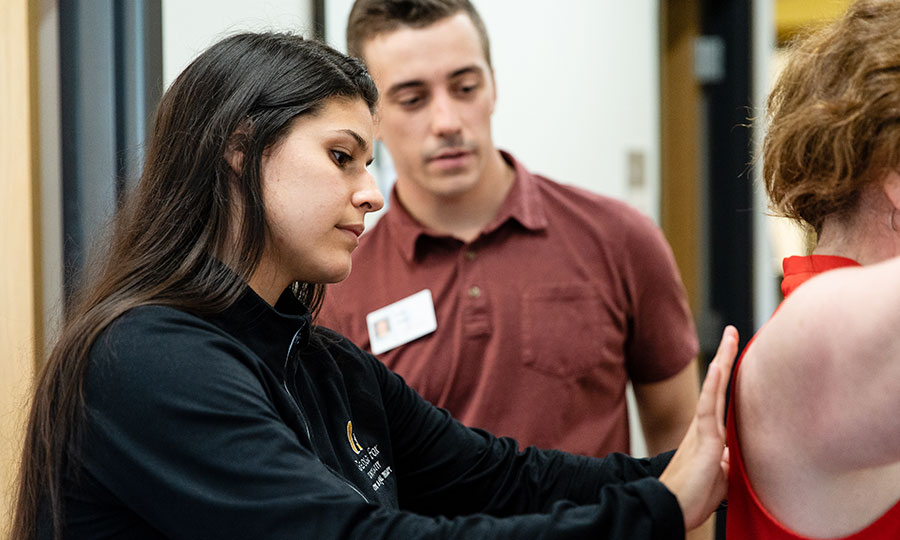 PT student working with a patient in clinic