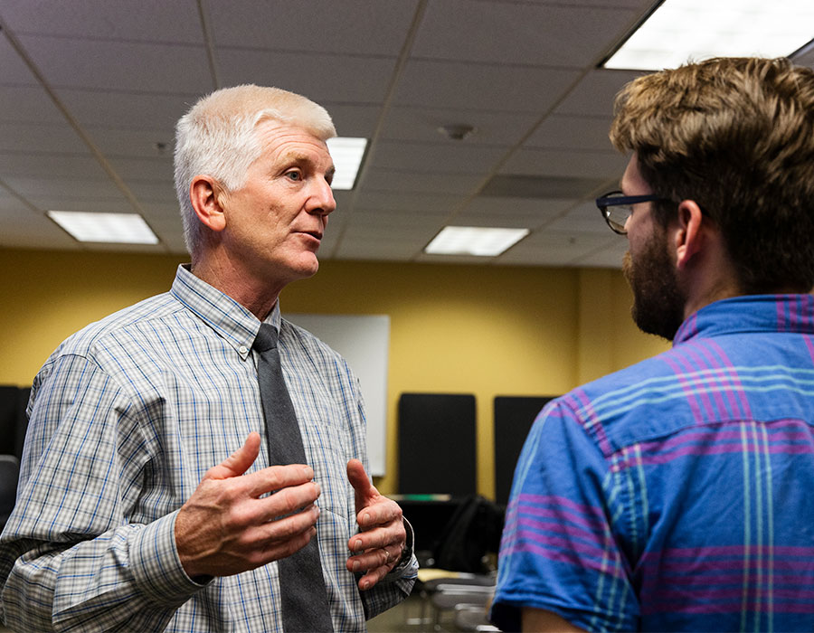 A faculty mentor talking with a student