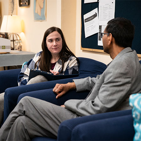 A student having a discussion with a professor