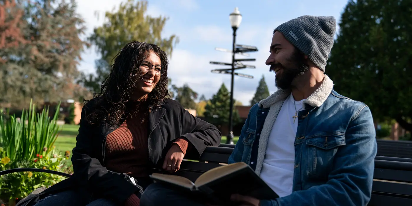 Two PSYD students have a conversation outside