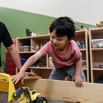 a child plays with a toy truck