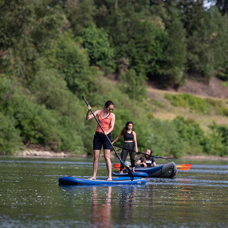 Three students on paddleboards