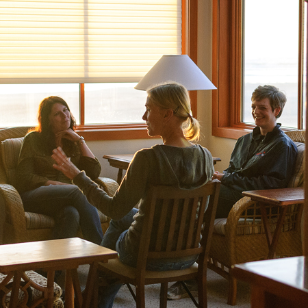 Three women having a conversation.