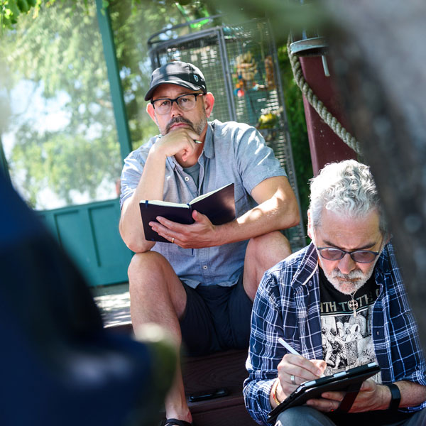 Two student sit on stairs outside and contemplate the bible