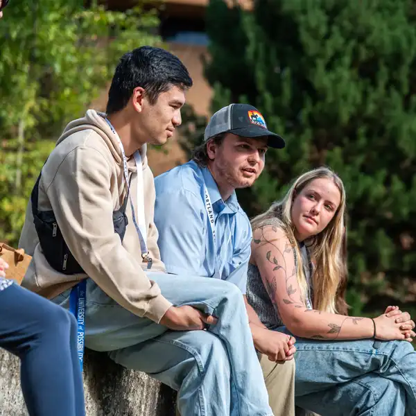 Seminary students engaging in discussion sitting outside