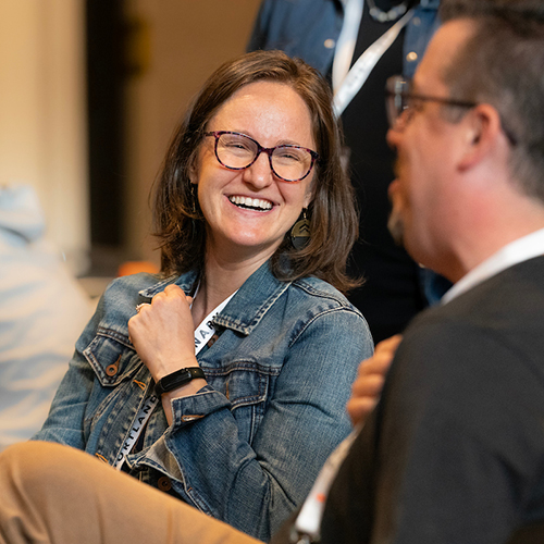 Woman smiling while having a conversation with someone else