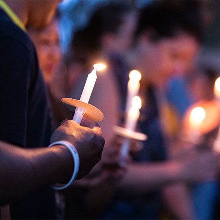 People holding lighted candles