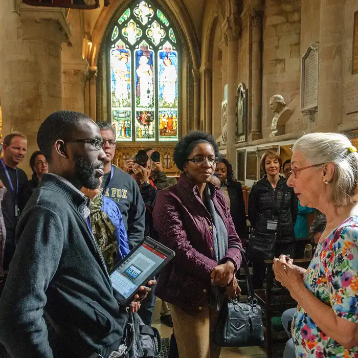 Portland Seminary program students speaking in a historic church setting