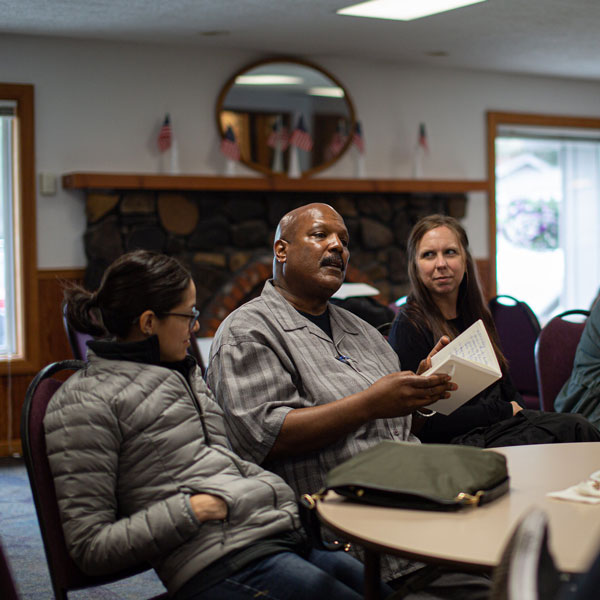 A cohort chats around a table