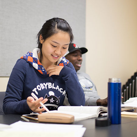 Two students talking in class