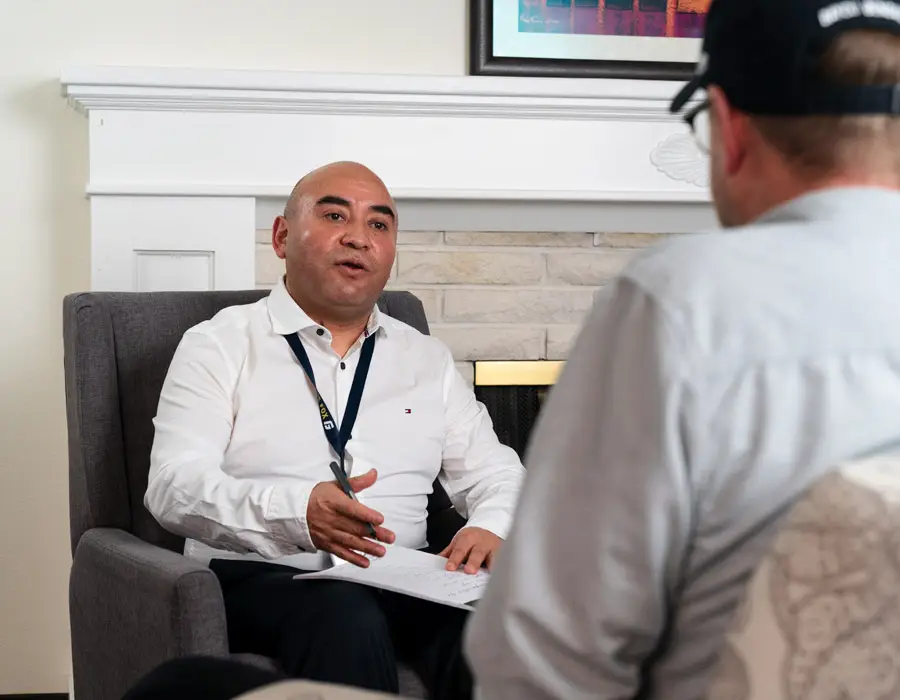 MSW graduate Alejo Ordonez speaks with a client in his office