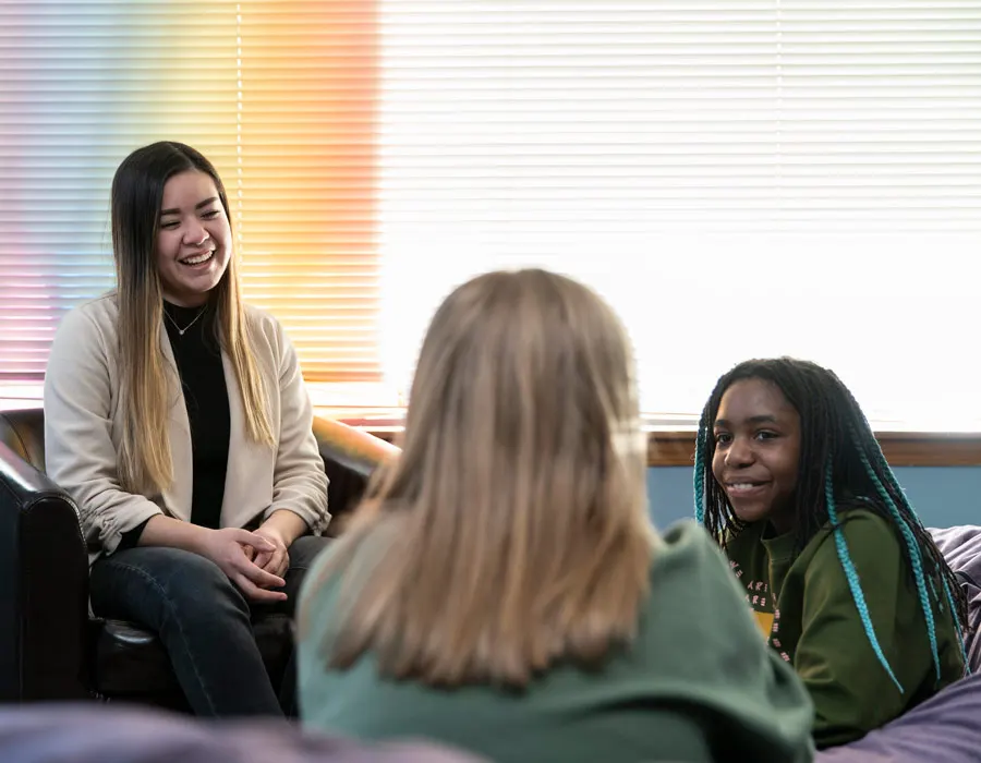 A social worker talking with a group of youth